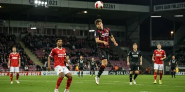 Defender heading a long ball clear from danger