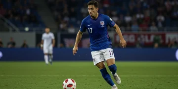 Dynamic American full-back dribbling forward in a professional soccer match