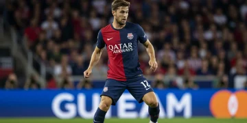 Dynamic image of a US soccer defender making a crucial tackle on the field.