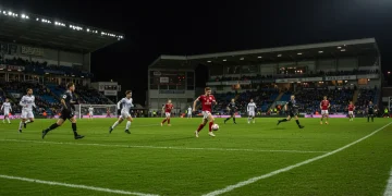 2026 World Cup Qualifiers: Counter-Attack Strategies for Strategic Wins Football player breaking away on a counter-attack during a 2026 World Cup Qualifier match under stadium lights.